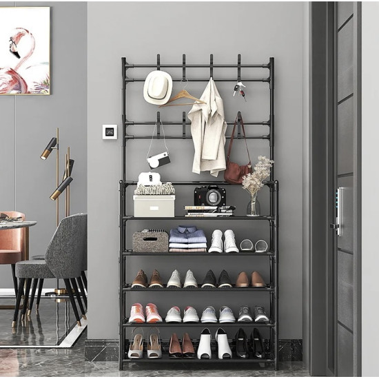 Black metal multi-tier stand with hooks for hanging clothes and bags, and shelves holding shoes and accessories