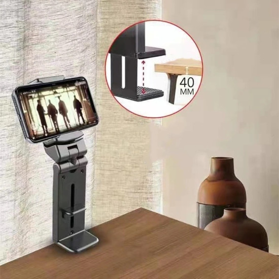 Black adjustable phone holder clamped on table edge holding a smartphone horizontally