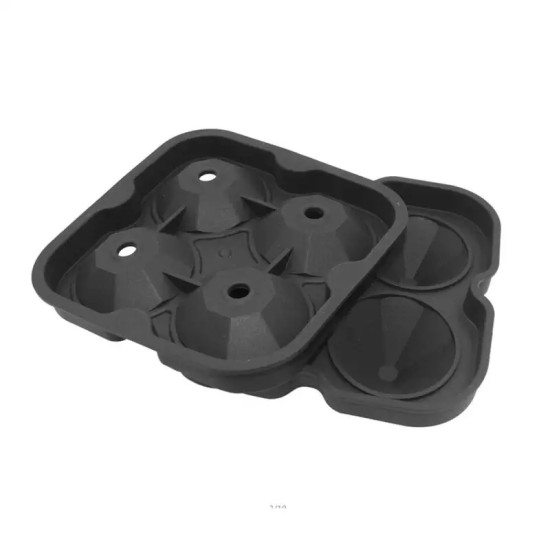 Black silicone ice cube mold open showing four large faceted cone-shaped cavities each with a small circular hole in the center, mold resting on white background