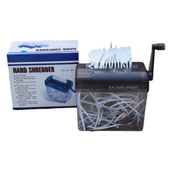 Manual hand crank paper shredder with black top and clear container shredding white paper into strips