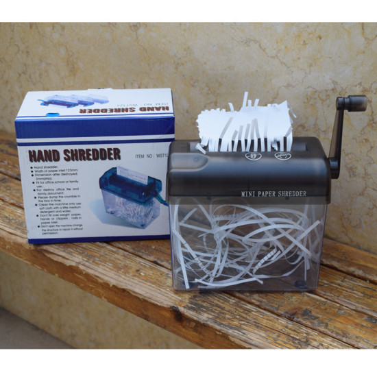 Manual hand crank paper shredder with black top and clear container holding curled shredded white paper strips