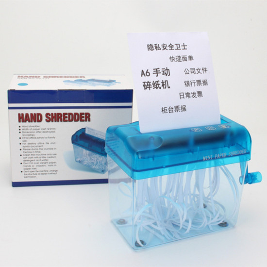 Mini hand crank paper shredder with blue translucent top and clear container holding curled white paper strips