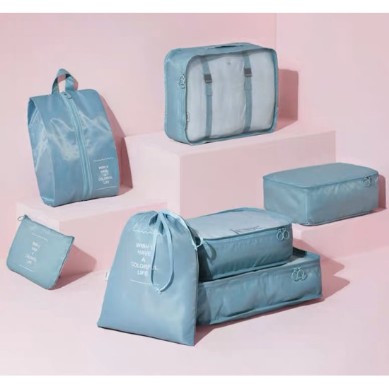 Blue travel bag organizer set with eight pieces including packing cubes, drawstring pouch, and shoe bag