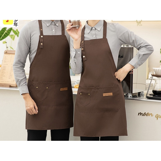Two brown aprons with buttoned neck straps and front pockets worn by people in gray shirts
