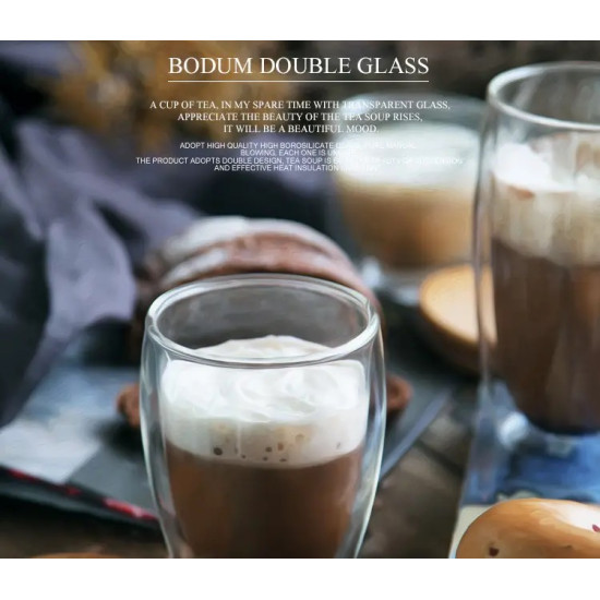 Clear Double Wall Glass Cup with Bamboo Lid Clear double wall glass cup filled with coffee and foam, with a round bamboo lid in the background
