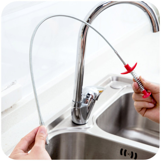 Flexible Metal Pickup Tool with Red Handles for Narrow Spaces Flexible metal pickup tool with red handles used to reach narrow spaces near a kitchen sink