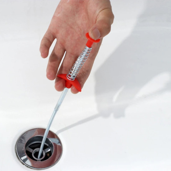 Flexible Metal Spring Grabber Tool with Red Handle Flexible metal spring tool with red handle inserted into a drain for grabbing objects