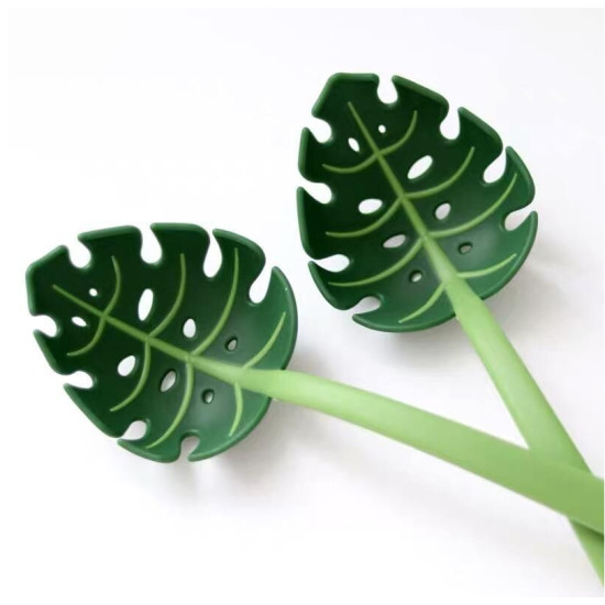 Green Plastic Monstera Leaf Serving Spoons Green plastic serving spoons shaped like monstera leaves with cut-out holes and light green handles