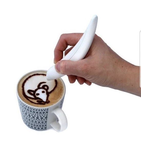 Hand using white curved pen to draw a mouse design on frothy coffee in a patterned cup