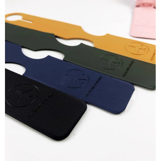 Set of leather luggage tags in black, blue, green, and yellow with embossed airplane logo and 'PLEASANT JOURNEY' text