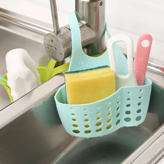 Light blue silicone holder with holes hanging on kitchen faucet holding sponge and cleaning tools