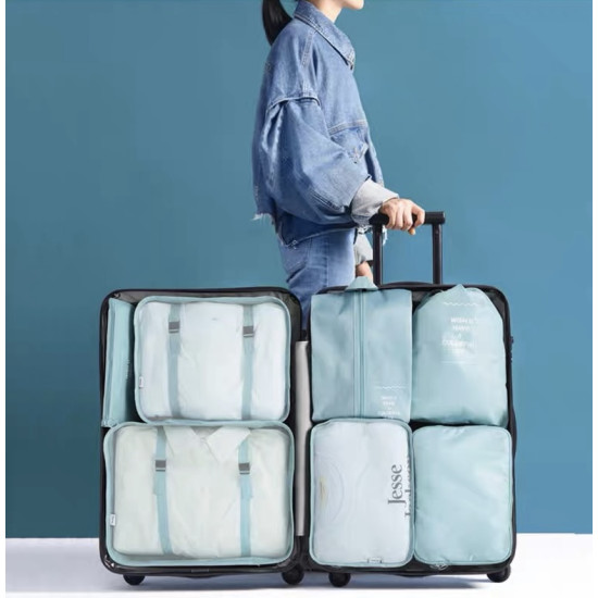 Light blue travel packing cubes set neatly organized inside an open suitcase with clothes visible