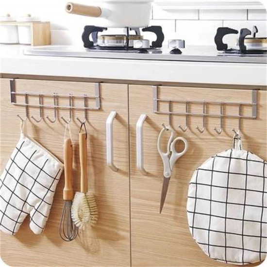 Metal kitchen cabinet door hanger with six hooks holding kitchen tools and oven mitts
