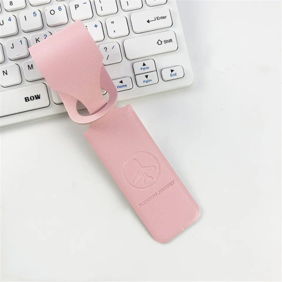 Pink leather luggage tag with embossed airplane logo and 'PLEASANT JOURNEY' text