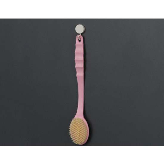 Pink long-handle body brush with yellow bristles hanging on a hook
