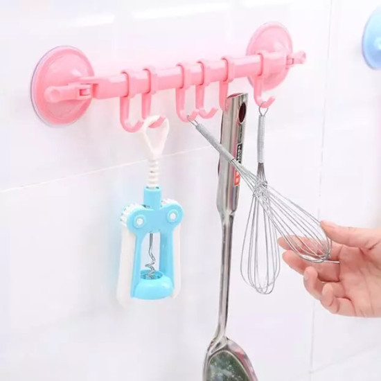 Multi-use No-Drill Suction Cup Hook Bar for Kitchen and Bathroom Pink suction cup hook bar mounted on white tiled wall holding kitchen tools including whisk and peeler