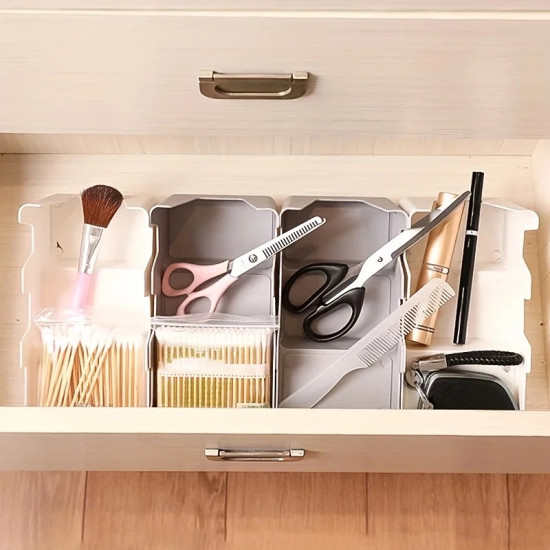 plastic drawer organizer with compartments holding scissors, comb, makeup brush, and cotton swabs