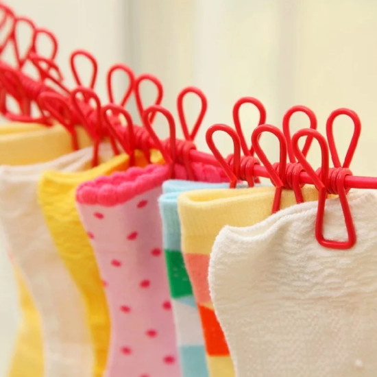Red elastic washing rope with 12 red looped clips holding colorful socks in close-up view
