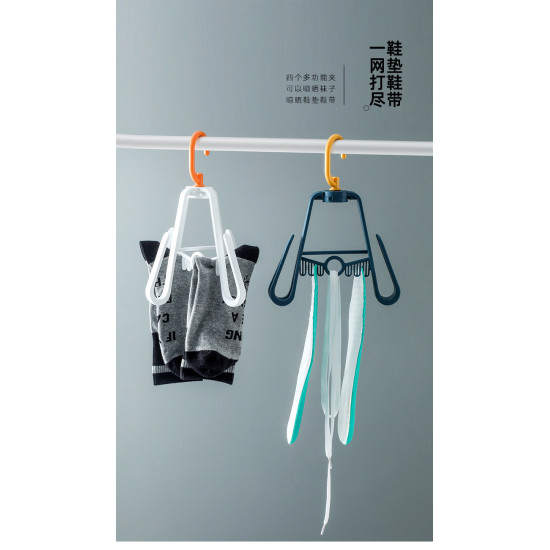 Two rotating hangers hanging on a white rod. The left hanger is white with an orange hook and has two pairs of gray and black socks clipped on its two large hooks. The right hanger is dark blue with a yellow hook and has several white and green shoe insol