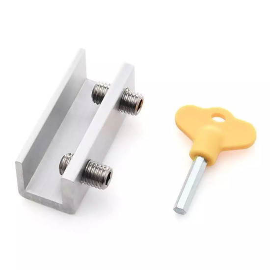 Silver U-shaped lock with two threaded bolts positioned horizontally inside the U shape, next to a yellow plastic key with a hexagonal metal shaft.