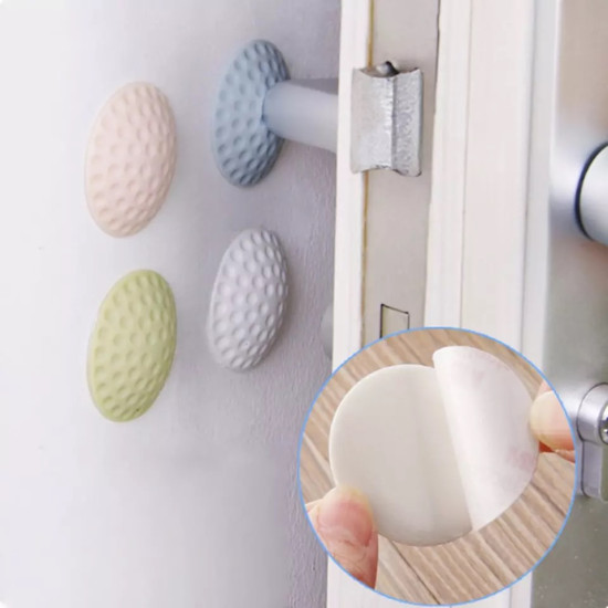 Textured rubber door bumpers in pastel colors attached to wall behind door handle to reduce impact