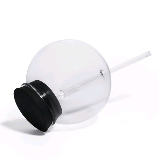 Transparent Spherical Glass Cup with Clear Straw and Black Lid Transparent spherical glass cup with a clear glass straw and a black lid placed on its side