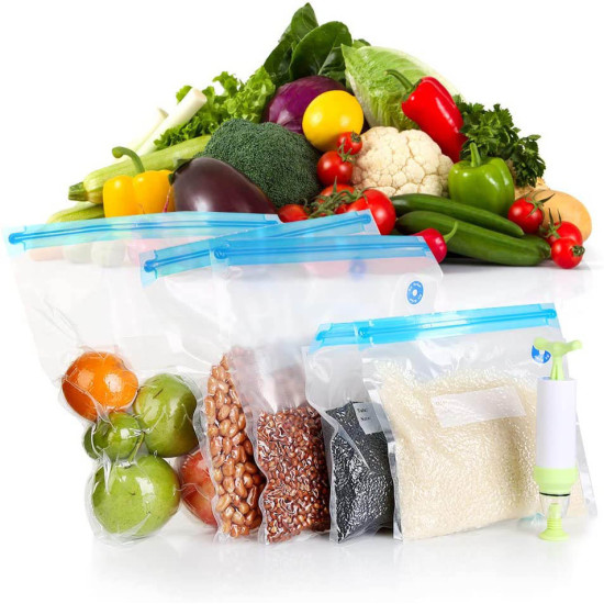 Five transparent vacuum seal bags with blue sealing strips arranged in a row containing oranges, green apples, peanuts, red beans, black beans, and white rice. Each bag has a round blue valve on the right side. A white and green manual pump is positioned 