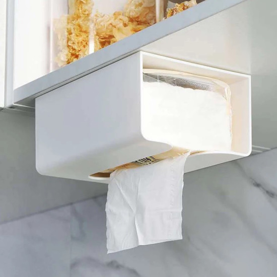 White Adhesive Under Cabinet Tissue Holder White adhesive tissue holder mounted under cabinet with tissue partially pulled out