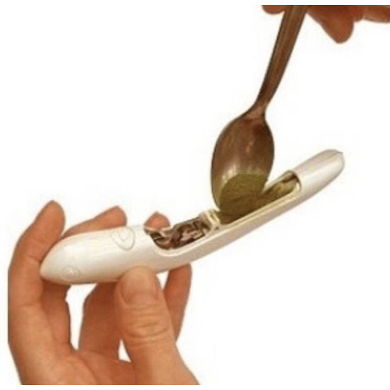White coffee and cake decoration pen being filled with powder using a spoon for latte art