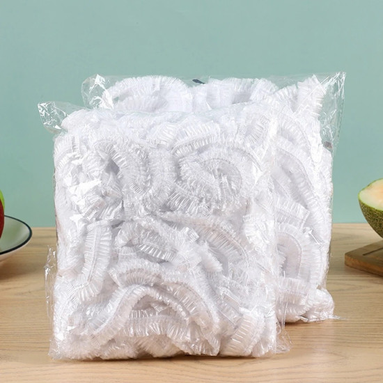 Pack of white elastic reusable food covers with gathered edges in clear plastic packaging