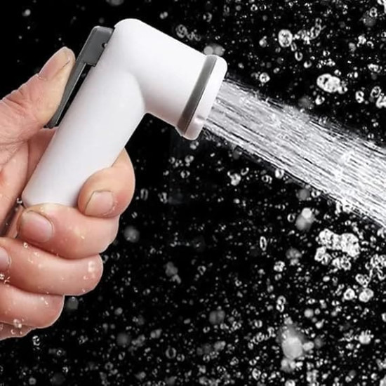 White handheld bidet spray with gray lever spraying a focused water stream on black background