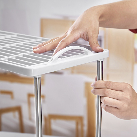 White plastic grid shelf with metal rods and built-in handle for easy carrying and assembly