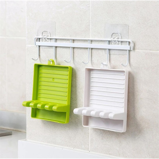Wall mounted hook bar with two hanging trays in green and white White wall-mounted horizontal bar with five evenly spaced downward hooks. Two rectangular trays with horizontal ridges and four rounded slots each hang from two of the hooks. One tray is green and the other is white. Both trays have a small hook at the to