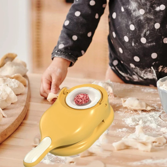 Yellow pastry dough press with a circular cavity holding a ball of minced meat filling