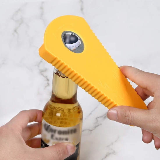 Yellow Ridged Bottle Cap Opener Yellow ridged bottle cap opener removing cap from a glass bottle